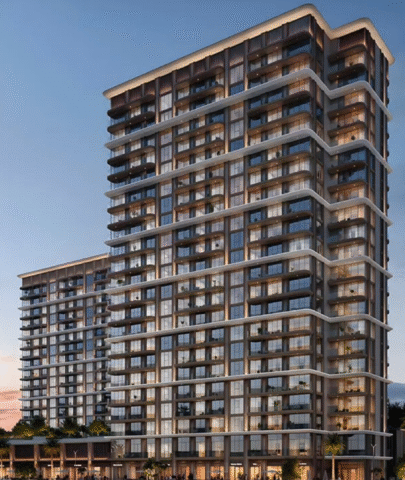 BAYSTAR residential building overlooking a marina with yachts at sunset.
