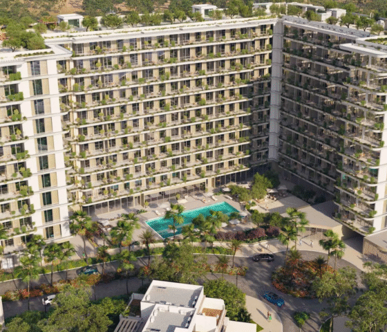 The exterior of California Residences, featuring tiered balconies with greenery and a landscaped entrance.