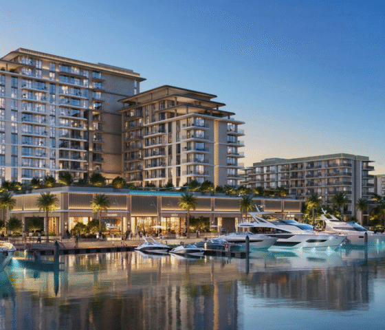The AUREA by EMAAR residential buildings at Rashid Yachts & Marina, viewed from the water with luxury yachts docked at the pier.