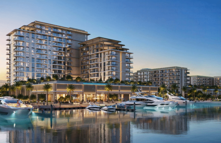 The AUREA by EMAAR residential buildings at Rashid Yachts & Marina, viewed from the water with luxury yachts docked at the pier.