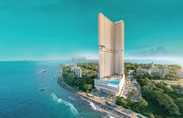 The BREEZ tower in Dubai Maritime City, showing its unique architectural design and proximity to the sea and Dubai skyline.