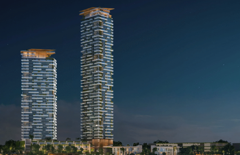 Night view of the two gleaming Soulever by Beyond towers, a luxury residential project in Dubai Maritime City.