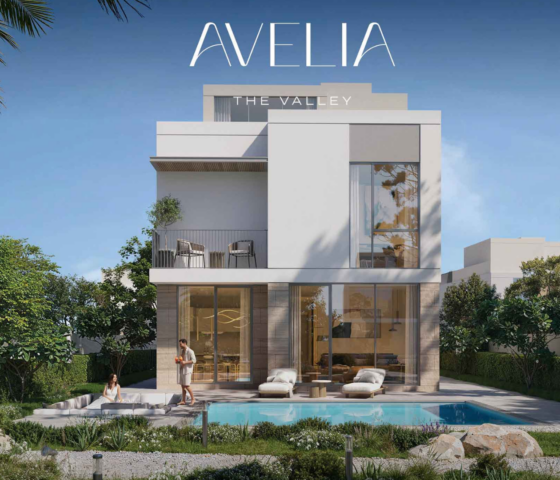 Residential view from a private balcony in The Valley, overlooking a landscaped community park with an outdoor fitness area and walking paths.