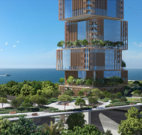 Waterfront commercial tower and surrounding park area in Dubai Maritime City.