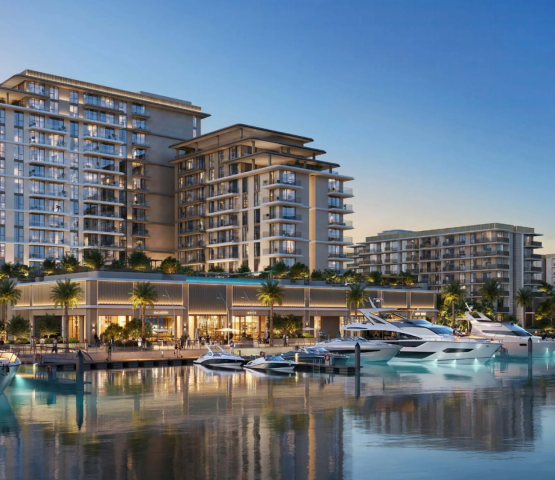 The AUREA by EMAAR residential buildings at Rashid Yachts & Marina, viewed from the water with luxury yachts docked at the pier.