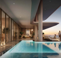 Stylish residential complex with outdoor seating, greenery, and high-rise skyline backdrop.