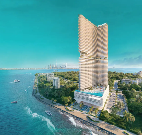 The BREEZ tower in Dubai Maritime City, showing its unique architectural design and proximity to the sea and Dubai skyline.