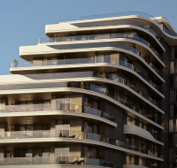 A close-up view of a modern residential building with a curved, flowing facade and expansive balconies with glass railings.