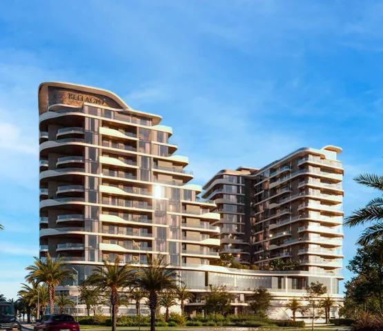 A modern residential building with a curved, layered facade, surrounded by palm trees under a clear sky.