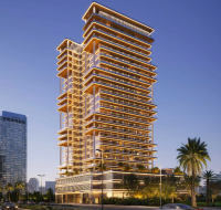 The illuminated exterior of the Binghatti Hillside residential tower in Dubai Science Park at dusk.