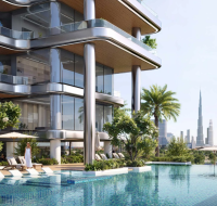 A modern poolside area beside a sleek glass building by developer Binghatti, surrounded by greenery with a distant city skyline.