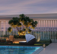 Rooftop pool and lounge by Binghatti with seating, greenery, and city views at dusk.