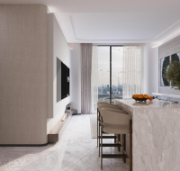 Contemporary living space at Binghatti Pinnacle with a marble kitchen island, bar seating, and floor-to-ceiling windows overlooking the city.