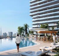 Binghatti Sky Terraces featuring a luxury infinity pool deck with sun loungers, landscaped leisure spaces, and modern high-rise architecture.