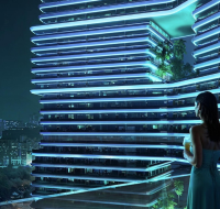 Woman standing on a balcony overlooking a futuristic illuminated high-rise with layered terraces and city skyline at night.