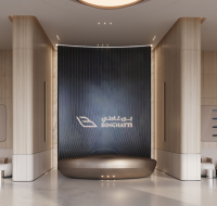 Luxury residential lobby interior featuring elegant seating areas, soft ambient lighting, modern wall art, and refined contemporary design.