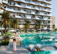 Luxury residential swimming pool and landscaped leisure area in Motor City, Dubai, featuring palm-lined decks and modern apartment balconies.