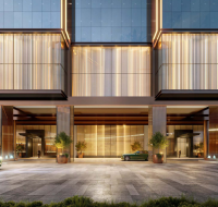 Elegant building entrance with parked luxury cars and warm lighting
