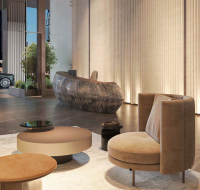 Lobby with modern seating, sculpted reception, and glass entrance