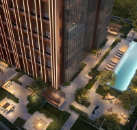 Aerial shot of leisure deck with pool, lounge chairs, and greenery
