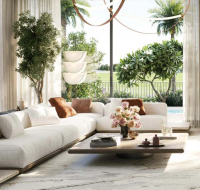 A bright living room in a Chevalia Estate 2 villa with floor-to-ceiling windows and a view of the pool and golf course.