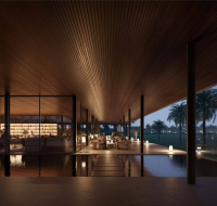 A modern outdoor lounge at dusk with a wooden ceiling, a bar, and seating areas next to a reflecting pool.