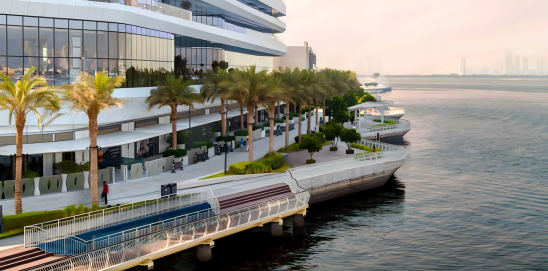 Creek Haven by Emaar – waterfront view of modern residential building in Dubai Creek Harbour with promenade, palm trees, and serene water reflections.