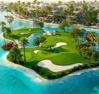 A beautiful golf putting green located on a small, lush island surrounded by a large turquoise lagoon and waterfront villas.