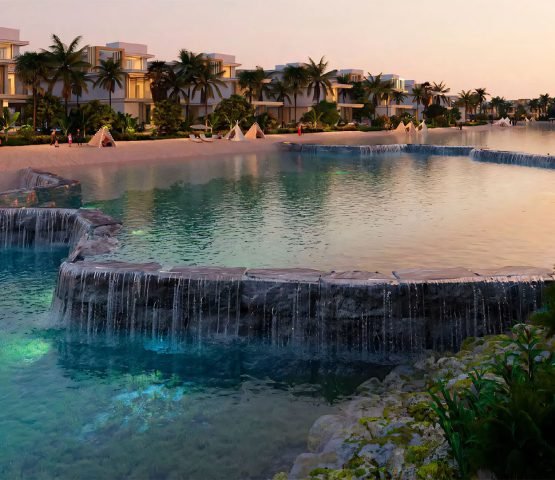 Tropical water features and man-made waterfalls within the DAMAC Islands residential community.