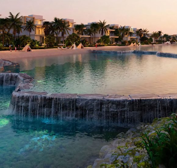 Tropical water features and man-made waterfalls within the DAMAC Islands residential community.