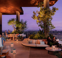 Contemporary apartment complex with curved glass facade, pool, and children's playground at Ghaf Woods