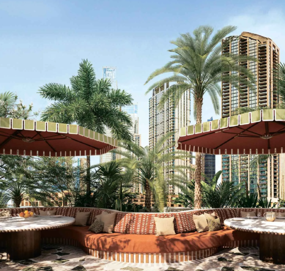 Outdoor lounge and seating area with lush greenery and a view of the Dubai cityscape .