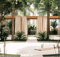 Outdoor wellness space at Elire Residences with a yoga mat, kettlebell, and a tropical garden setting.