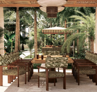 Resort-style outdoor dining area with a wooden pergola and lush tropical greenery.