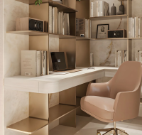 Home office space with laptop, books, and comfortable chair