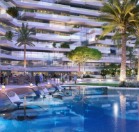 Infinity pool with sun loungers and landscaped surroundings at a modern residential complex