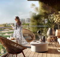 Woman enjoying coffee on a stylish balcony with scenic green landscape views