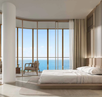 Spacious modern living room with panoramic glass windows and elegant interior decor.