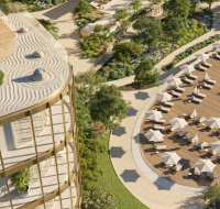 Modern residential towers surrounded by greenery and leisure amenities seen from above.
