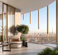Modern balcony lounge with panoramic city view by Beyond Developers, featuring elegant seating, greenery, and floor-to-ceiling glass panels.