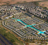 Aerial view of the Dubai South community, showing Lilian Residences and the surrounding green areas