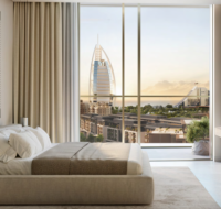 Cozy bedroom with ample natural light and elegant finishes.