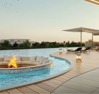 Infinity pool at Ocean Bay Dubai with fire pit lounge and sunset view