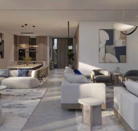 Open-plan living and dining room with modern white sofas and abstract pendant lighting.