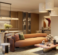 Modern open-plan living room with a brown sofa, marble coffee table, cozy armchairs, and dining area with contemporary lighting.