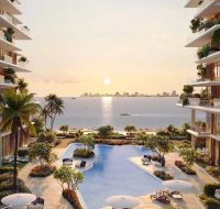 The beautiful central courtyard and swimming pool of Silena Residences, overlooking the sea at sunset.