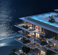 Modern multi-story residences with spacious balconies overlooking the sea .