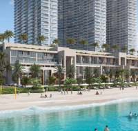 Beachfront residences with tall glass towers, palm trees, and people enjoying activities by the water.