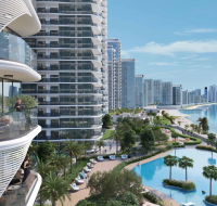 A group of modern high-rise apartment towers in Umm Al Quwain, featuring curved architectural facades.