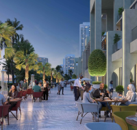 Outdoor dining promenade at a development by Sobha Realty, featuring people seated at tables and palm trees at dusk.